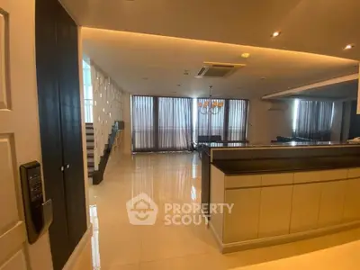 Spacious modern living room with open layout and elegant lighting, perfect for luxury living.