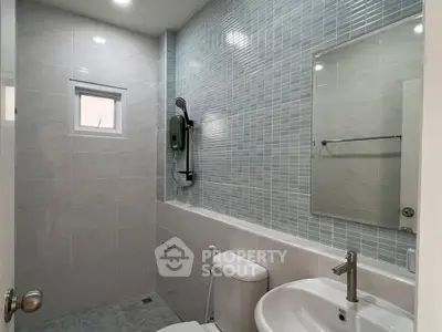 Modern bathroom with sleek fixtures and stylish tile design, perfect for a contemporary home.