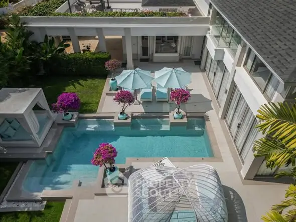 Luxurious villa with private pool and elegant outdoor seating area, perfect for relaxation and entertainment.