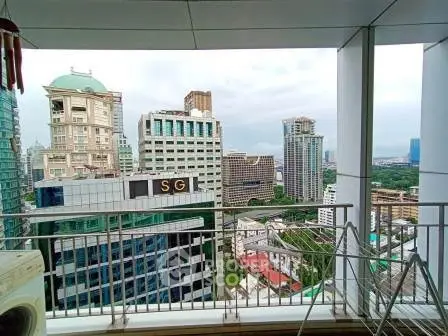 Stunning cityscape view from a high-rise balcony with modern railing and urban skyline.