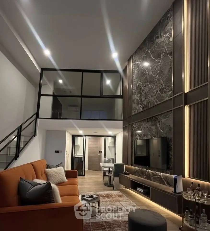 Luxurious modern living room with high ceilings, elegant lighting, and stylish decor in a contemporary home.
