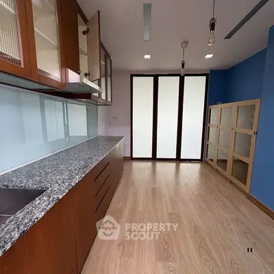 Spacious kitchen with modern cabinetry and granite countertops