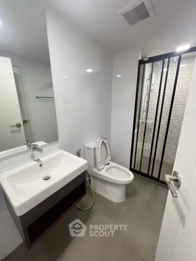 Modern bathroom with sleek fixtures and glass shower enclosure