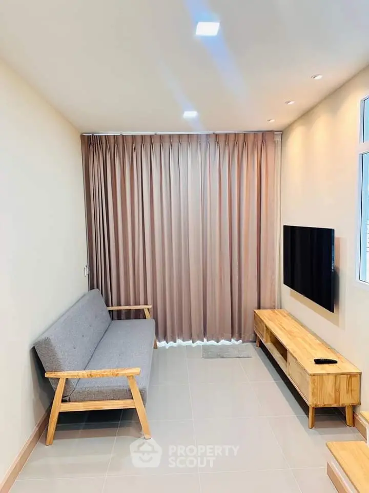 Modern living room with sleek furniture and large window curtains