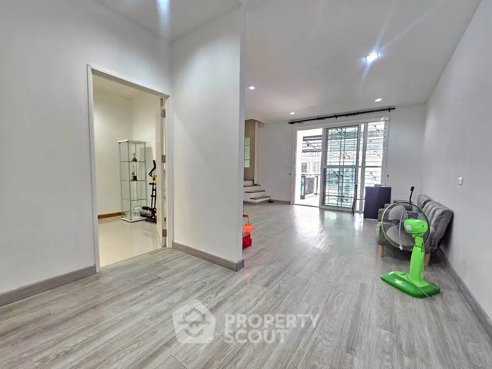 Spacious modern living room with sleek flooring and natural light