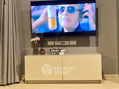 Modern living room with mounted TV and sleek cabinet