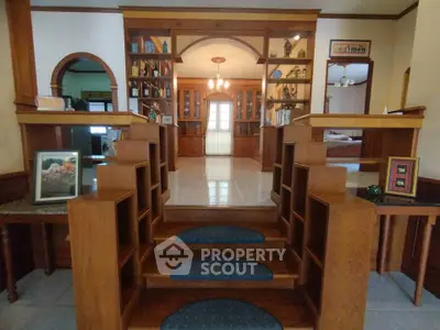 Elegant interior with wooden shelves and decorative elements in a spacious living area.