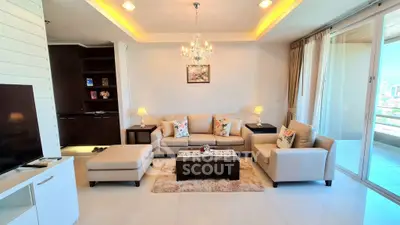 Luxurious living room with elegant chandelier and city view balcony