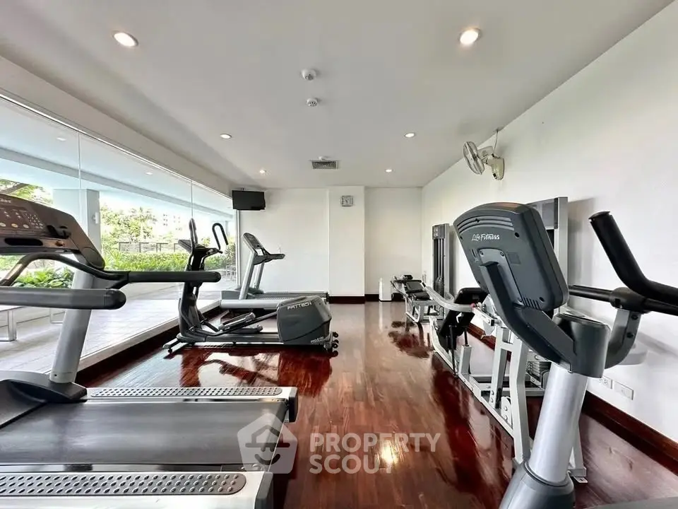 Modern gym with state-of-the-art equipment and polished wooden floors