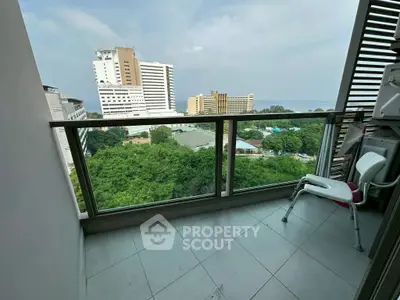 High-rise balcony with stunning city and ocean view, perfect for relaxation.