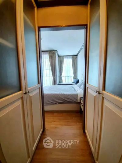 Elegant bedroom with walk-in closet and large windows for natural light