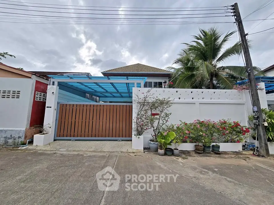 Charming suburban house with a gated entrance and lush garden, perfect for family living.