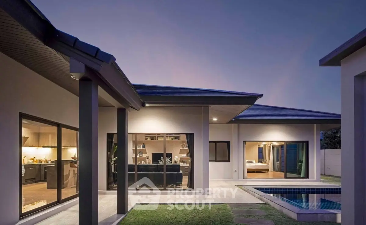 Modern luxury home exterior with pool and large windows at dusk, showcasing elegant architecture and inviting ambiance.