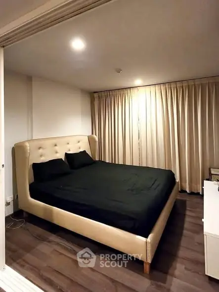 Cozy bedroom with elegant bed and soft lighting, perfect for relaxation.