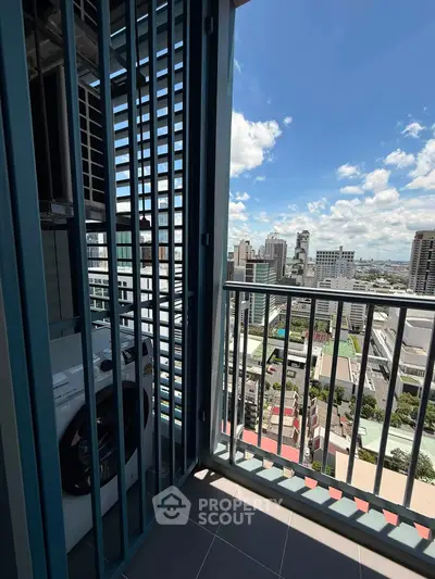 Stunning high-rise balcony with cityscape view and modern washing machine setup.