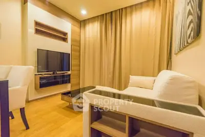 Modern living room with cozy seating and mounted TV in stylish apartment.