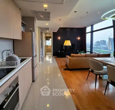 Luxurious open-plan kitchen and living room with stunning city view, modern furnishings, and elegant lighting.