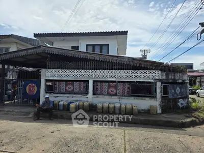 Charming two-story house with traditional design and decorative exterior elements.