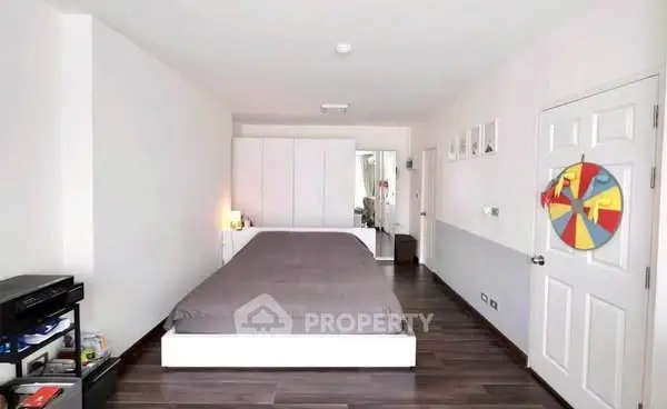 Spacious modern bedroom with sleek design and ample storage