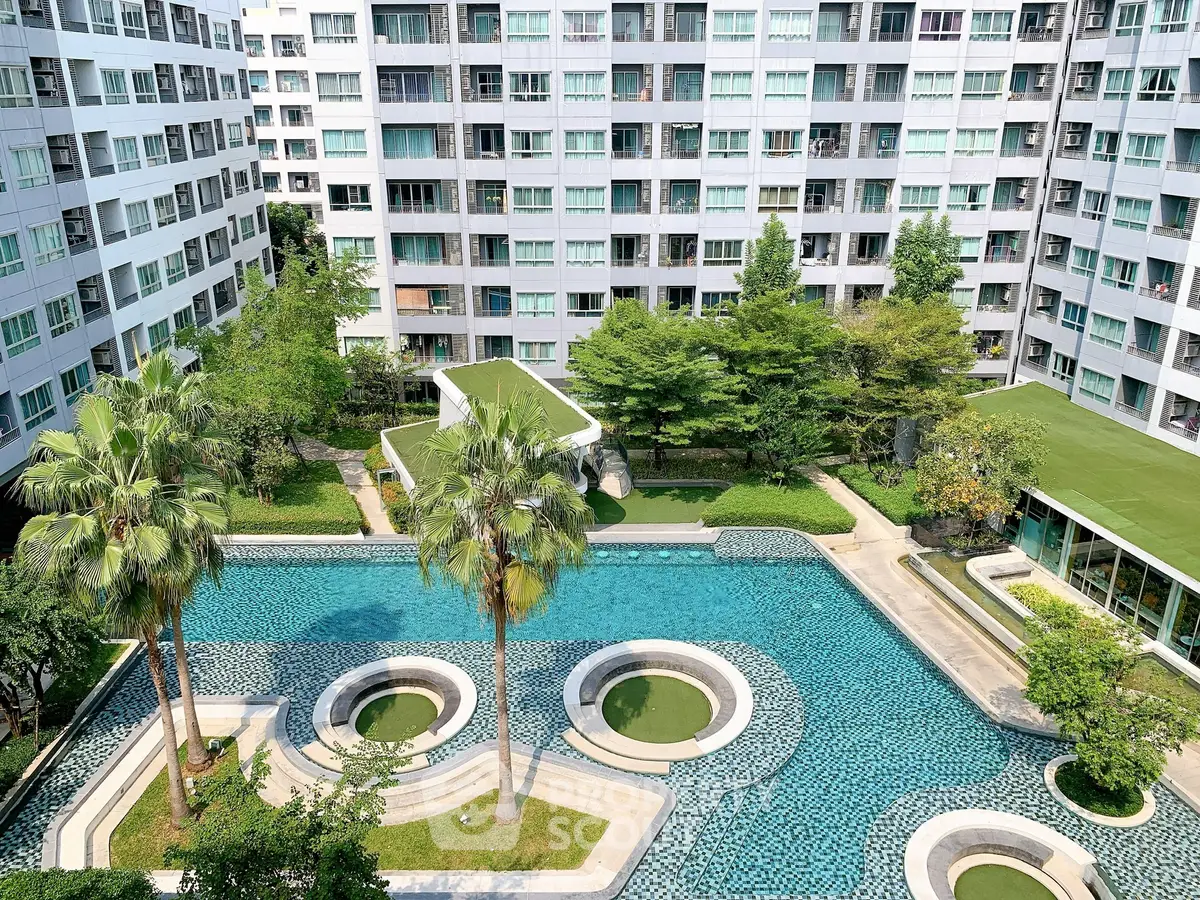 Luxurious condominium with stunning pool and lush greenery, perfect for modern living.