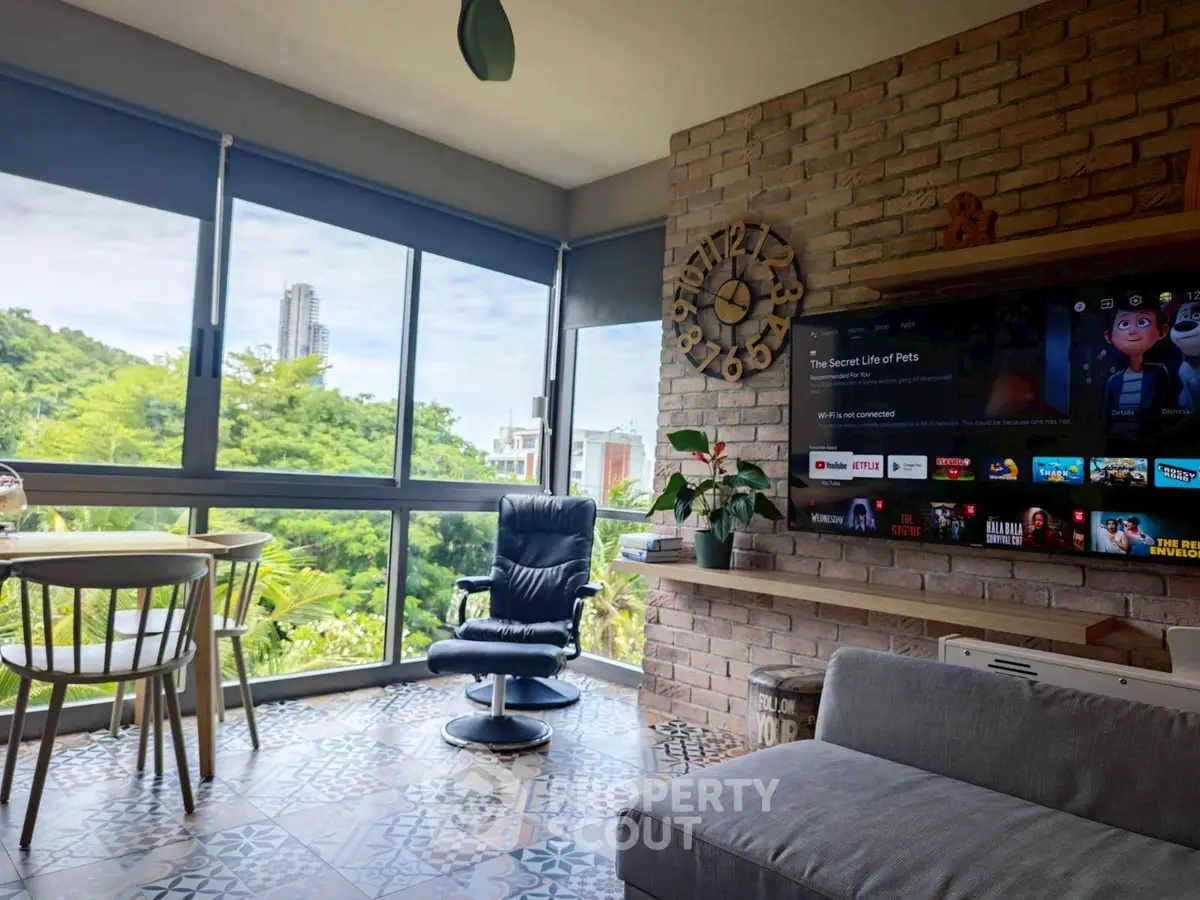 Modern living room with large windows, stylish decor, and scenic view.