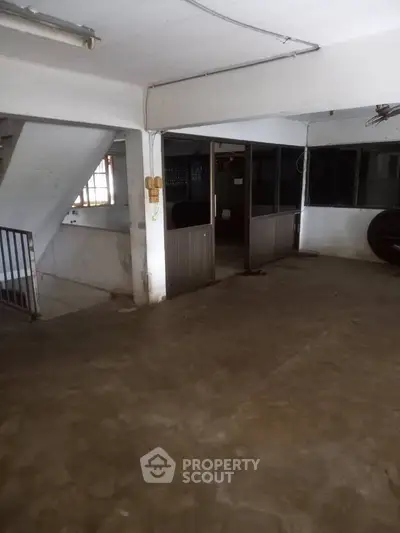 Spacious industrial-style basement with concrete floors and open layout, ideal for storage or workshop use.
