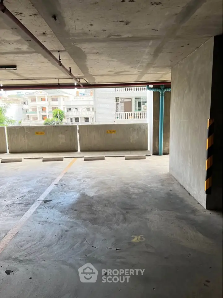 Spacious indoor parking area with ample natural light and secure surroundings.