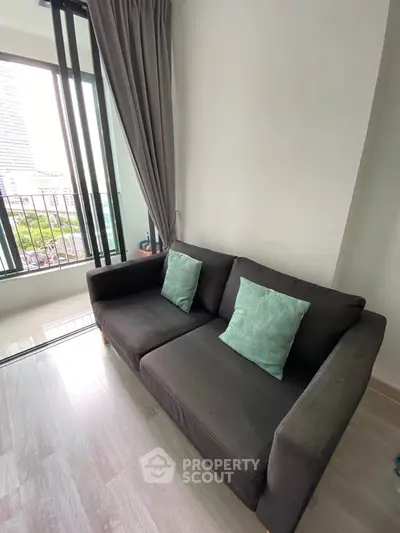 Modern living room with cozy sofa and city view from large window