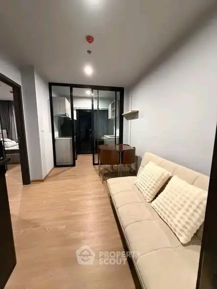 Modern living room with sleek glass partition and cozy seating area