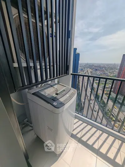 High-rise balcony with washing machine and city view, perfect for urban living convenience.