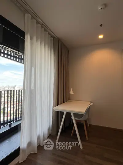 Modern study area with balcony view in high-rise apartment