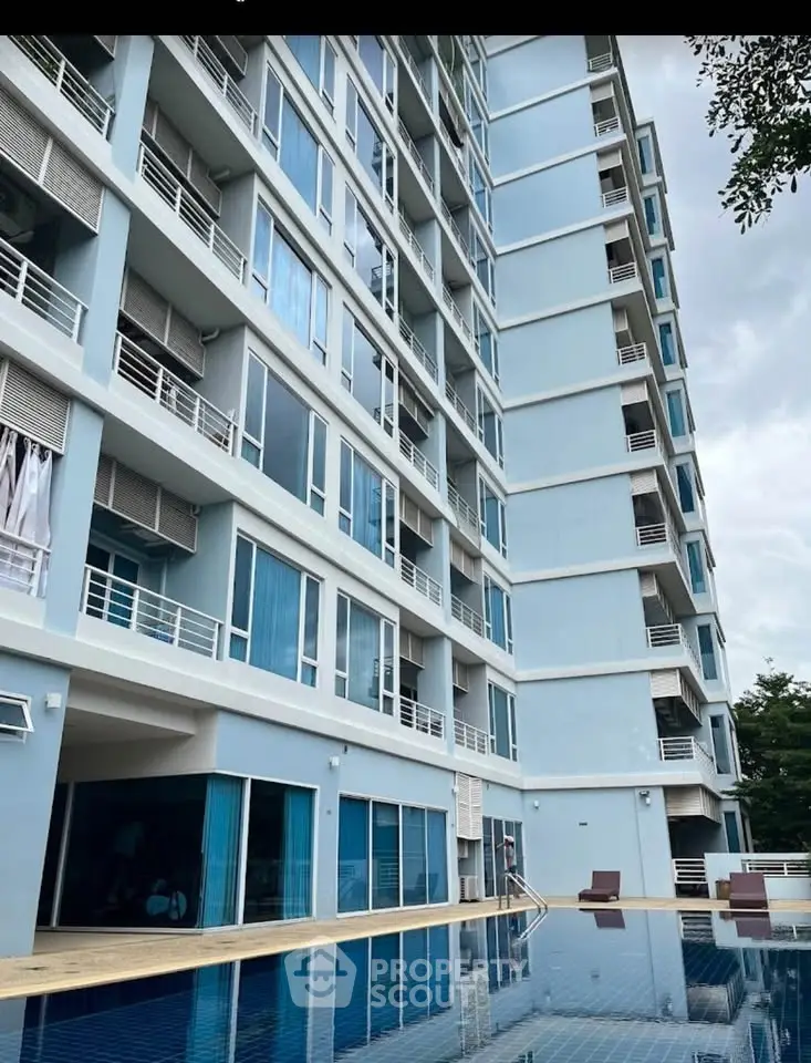 Modern high-rise building with pool and spacious balconies