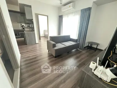 Modern living room with sleek furniture and open kitchen layout