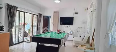 Spacious living room with pool table and modern decor