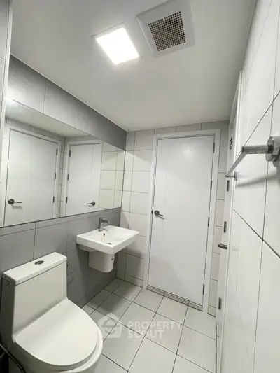 Modern bathroom with sleek white tiles and minimalist fixtures