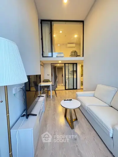 Modern loft-style living room with high ceilings and elegant decor