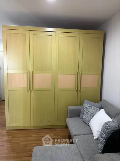 Spacious living room with stylish wardrobe and comfortable sofa