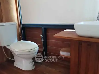 Modern bathroom with wooden accents and sleek fixtures