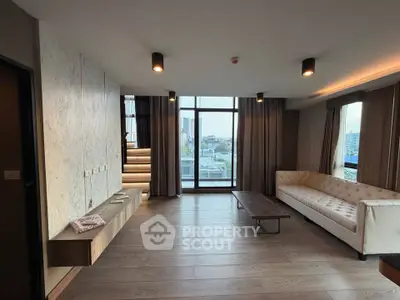 Spacious modern living room with large windows and city view