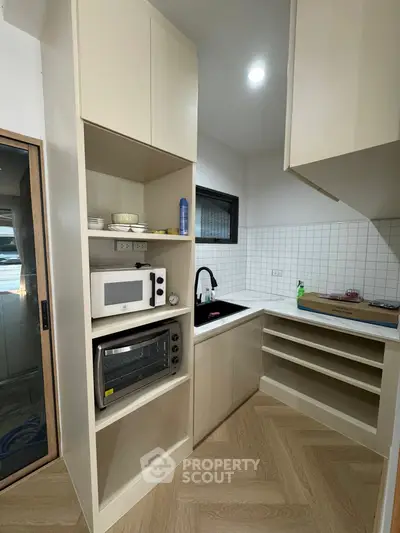 Modern kitchen with built-in appliances and sleek cabinetry