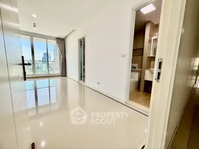 Spacious modern apartment with city view and sleek tiled flooring, featuring a bright open layout.