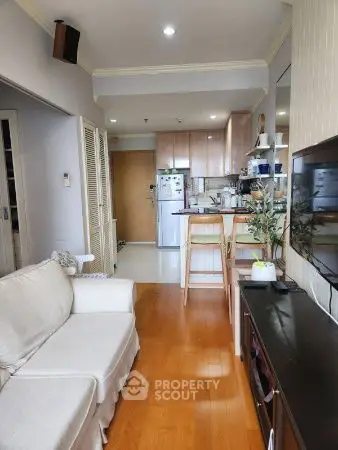 Cozy living room with open kitchen layout and modern appliances