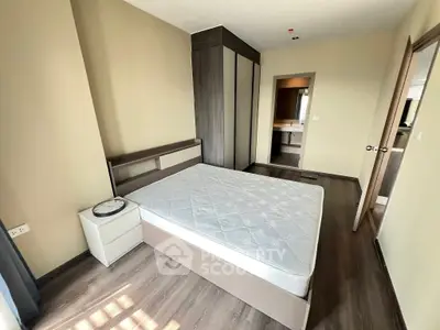 Modern bedroom with sleek wardrobe and natural light, perfect for cozy living.