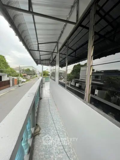 Spacious balcony with street view and modern railing design