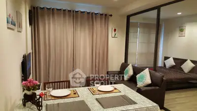 Cozy living room with dining area and modern decor in open layout apartment.