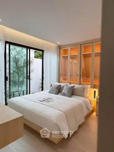 Elegant bedroom with large windows and modern decor, featuring a cozy bed and ample natural light.