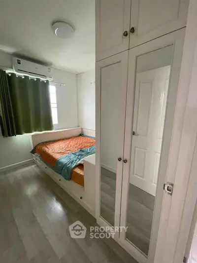 Cozy bedroom with mirrored wardrobe and natural light