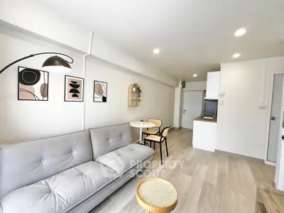 Modern living room with stylish decor and cozy seating in a bright apartment.