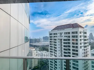 Stunning cityscape view from a high-rise balcony with modern architecture.