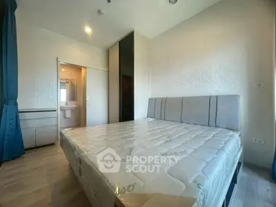 Modern bedroom with stylish decor and ensuite bathroom in a contemporary apartment.